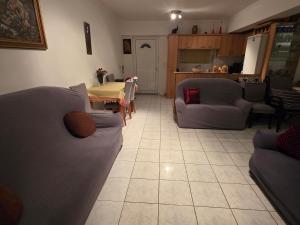 a living room with two couches and a table at Ariadni's Dreamhouse in Akrata +3 photos