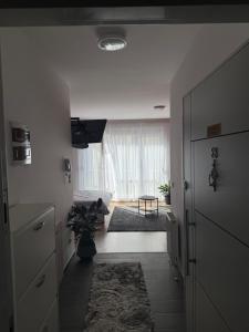 a hallway with a living room with a window at Apartament-in center of prishtina 3 in Pristina +3 photos