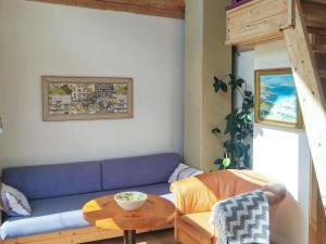 a living room with a blue couch and a table at 5 person holiday home in Floda in Floda +7 photos