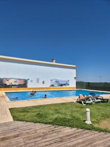 a building with a swimming pool with people in it at 1 Bedroom apt with pool access in Albufeira