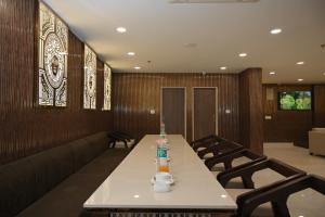 a conference room with a long table and chairs at Ayaan Residency in Noida