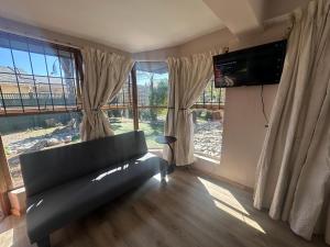 a living room with a couch and a large window at Suite Dreams Garden Dream Cottage in Panorama