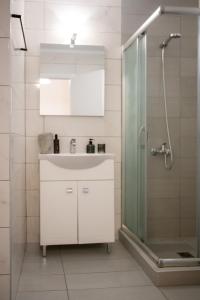 a bathroom with a white sink and a shower at Zoufi Cozy Living in Patra +38 photos