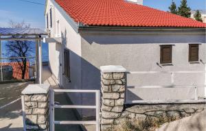 a white building with a gate and a red roof at Amazing Apartment In Kraljevica With Wifi in Kraljevica