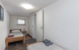 a bedroom with two beds in a room with a window at Amazing Apartment In Kraljevica With Wifi in Kraljevica