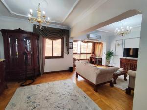 a living room with a couch and a chair at Where landsacpe view meets Luxury in Cairo