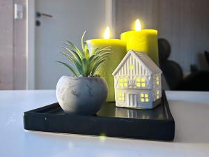 a black tray with a house and two candles at 4 star holiday home in Roslev in Roslev