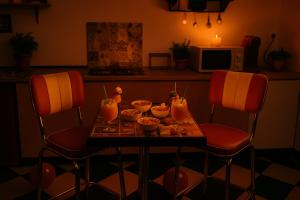 a table with bowls of food on it with two chairs at L'immortel gîte vintage avec ou sans spa in Cauchy-à-la-Tour