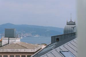 a building with a clock tower on top of it at Magia y Paz en Vigo, Mina Neptuno by CABANA Rentals in Vigo