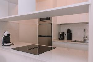 a kitchen with a stainless steel refrigerator and a sink at Magia y Paz en Vigo, Mina Neptuno by CABANA Rentals in Vigo