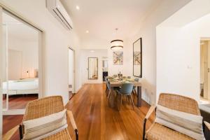 a dining room with a table and chairs and a bedroom at Private Pool Chiado Gem, Patio Retreat wAC in Lisbon