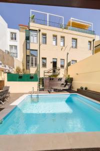 a swimming pool in front of a building at Private Pool Chiado Gem, Patio Retreat wAC in Lisbon