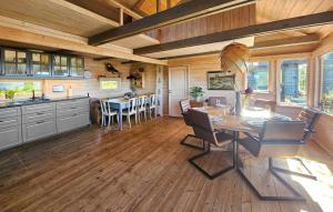a kitchen and dining room with a table and chairs at 5 Bedroom Stunning Home In Eggedal in Eggedal