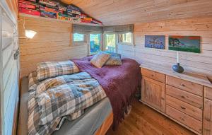 a bedroom with a bed in a wooden cabin at 5 Bedroom Stunning Home In Eggedal in Eggedal