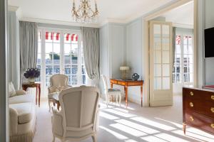 a living room with a table and chairs at Le Bristol Paris, Oetker Hotels in Paris