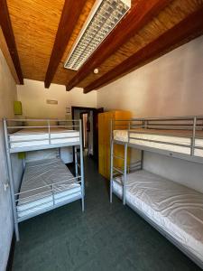 a room with three bunk beds in it at ALBERGUE DE LASTUR in Deba +44 photos