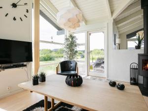 a living room with a table and a chair at 6 person holiday home in Hirtshals in Hirtshals