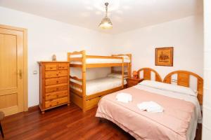a bedroom with a bunk bed and a dresser at Parque d'Arratiecho l Wifi l Céntrico l Amplio in Biescas