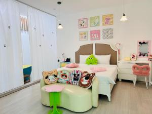 a childs bedroom with a bed and a chair at Pisces Hotel Hue in Hue