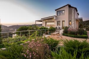 a house on a hill with a view at Luxury Villa Hara with private pool in Agia Pelagia