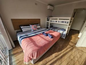 a bedroom with two beds and a bunk bed at Ocean Glimpse in Cape Town +29 photos