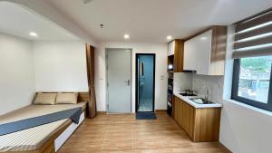 a small room with a bed and a kitchen at Era Apartment Tam Da in Hanoi