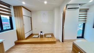 a living room with a table in the middle of a room at Era Apartment Tam Da in Hanoi