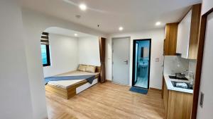 a small bedroom with a bed and a bathroom at Era Apartment Tam Da in Hanoi