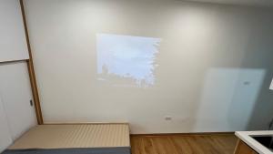 a room with a white wall with a painting on it at Era Apartment Tam Da in Hanoi +31 photos