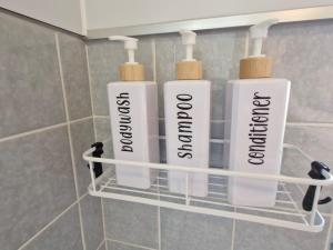 three bottles ofodorizers are on a shelf in a bathroom at NEU! FeWo AllerGrün, Balkon mit Blick in die Natur in Borstel +10 photos