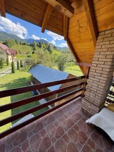 a view from the balcony of a house with a roof at Pensiunea Margareta corp A, Ceahlau in Ceahlău