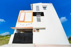 a white lighthouse with a sign on it at Collection O Neelambur Near PSG ITech in Irugūr +14 photos