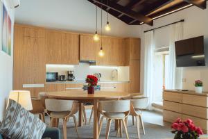a kitchen with a wooden table and chairs at Reverence Villas Avieira in Carballal +14 photos