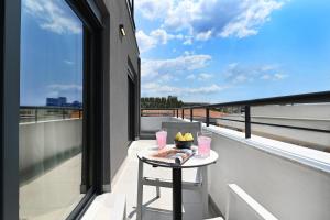 a table on a balcony with a view at ICON Urban Living in Thessaloniki
