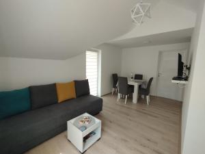 a living room with a couch and a table at Oaza apartman in Soko Banja