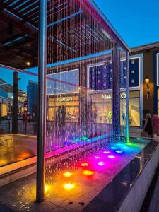a bird cage with colored lights on the side of a building at Viva La Zenia in Orihuela Costa