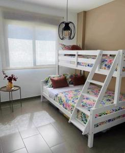 a bedroom with two bunk beds and a window at Viva La Zenia in Orihuela Costa +9 photos