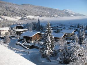 a resort in the mountains with snow on the ground at Ferienhaus Kuchelberg in Altenmarkt im Pongau