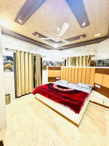 a bedroom with a bed with a red blanket at velvet villa mahabaleshwar in Mahabaleshwar