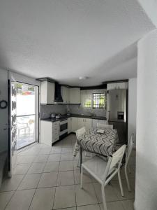 a kitchen with a table and chairs in a room at Villa Angie in Sani Beach
