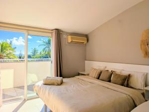Saint-PaulにあるHorizon plage - 3 chambres et spaのベッドとバルコニーのある寝室 +27枚の写真