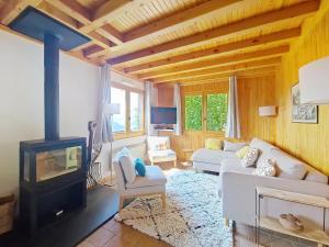 a living room with a white couch and a fireplace at CHALET AVORAZ AVR NATURE & VIEW 10 Pers in Châtel