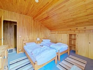 two beds in a room with a wooden ceiling at CHALET AVORAZ AVR NATURE & VIEW 10 Pers in Châtel