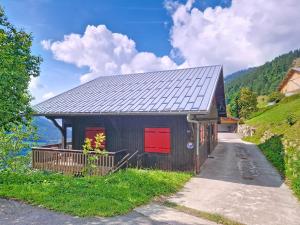 a small building with a red door on a mountain at CHALET AVORAZ AVR NATURE & VIEW 10 Pers in Châtel