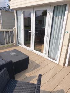 a screened in porch with a table and chairs at cleethorpes beach in Humberston