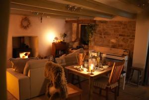 a living room with a couch and a table at The Little Welsh Cottage in Brynmenin