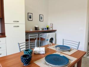a wooden table with blue plates on it in a kitchen at Casa del Grillo in Messina