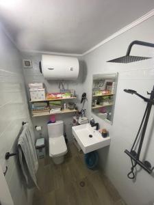 a bathroom with a white toilet and a sink at Sweet Home villa in Tirana +26 photos