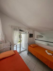 a bedroom with two beds and a balcony at Villa Angie in Sani Beach