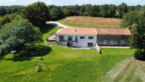 an aerial view of a large house in a field at Gîte au bord du lac - 4-10 pers - La Roche sur Yon in La Roche-sur-Yon